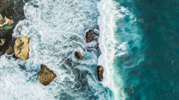 istock Aerial view of crashing waves on rocks 1144235574