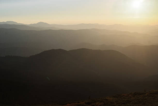 istock The mountains on a sunny day and sunset with clouds and coniferous forest. Landscape 1144236105