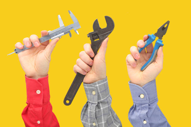 istock Raised male hands with different gestures and objects of the profession 1144238736