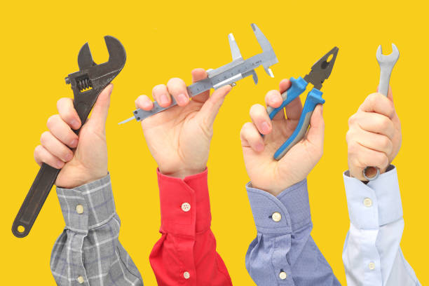 istock Raised male hands with different gestures and objects of the profession 1144238798