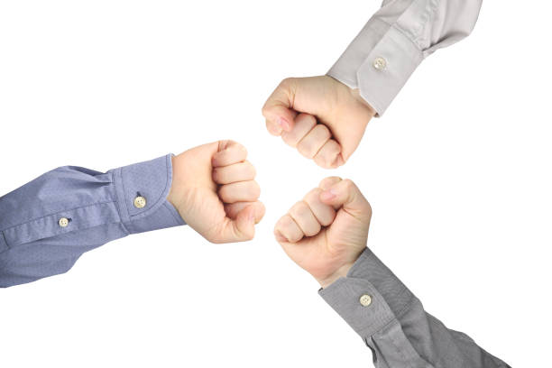 istock Three male hands clenched into fists opposite each other on a white background 1144238887