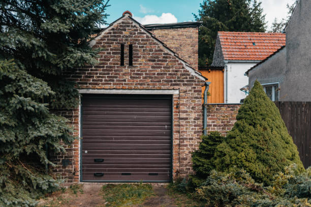istock Traditional european garage with red brick and brown gate 1144238943