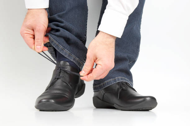 istock Man tying shoelaces on classic shoes 1144240824
