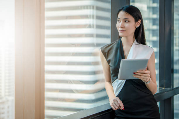 istock Asian business woman using tablet computer in office 1144242320