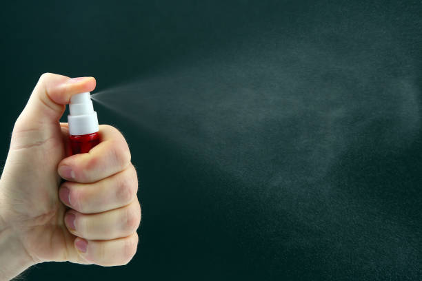 istock spray gun with liquid sprinkles in hand 1144242410