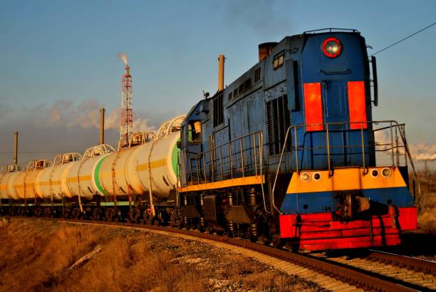 istock Locomotive pulls cisterns in the morning sun. 1144244679