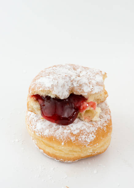 istock Comfort food in Canada: two sugar dusted jam stuffed donuts on wihte 1144244785