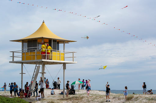 Semaphore, South Australia, Australia - April 20, 2019: Families and surf rescue staff  by the Semaphore Lifeguard Tower during the Adelaide International Kite Festival 2019.