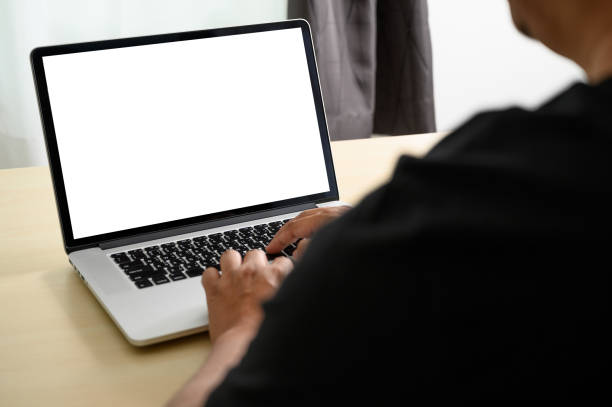 istock man working on his laptop with blank copy space Laptop with blank screen Mock up Blank screen computer 1144247580