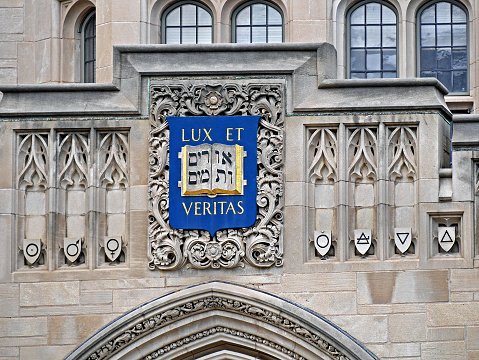 New Haven, CT, USA - June 25, 2015:  Yale University, ornate building facade with Hebrew and Latin mottos on crest