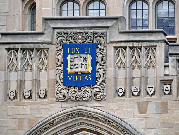 Yale University, ornate building facade with Hebrew and Latin mottos on crest New Haven, CT, USA - June 25, 2015:  Yale University, ornate building facade with Hebrew and Latin mottos on crest motto stock pictures, royalty-free photos & images