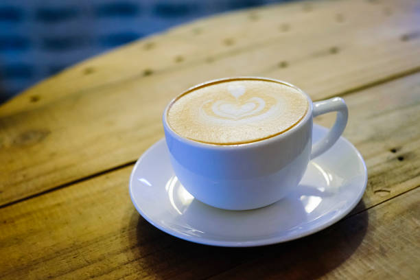 istock Cups of cafe latte on wooden table background 1144249277