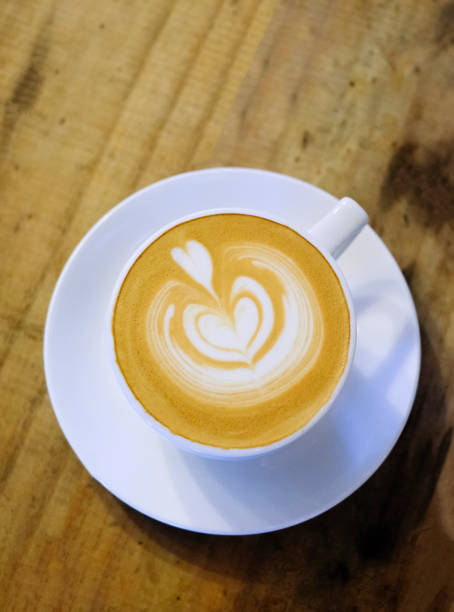 istock Cups of cafe latte on wooden table background 1144249290