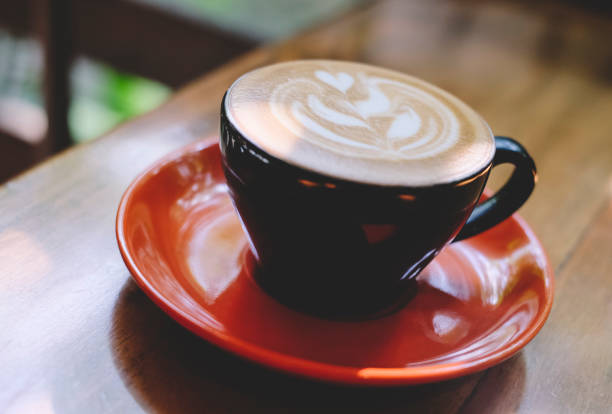istock Cups of cafe latte on wooden table background 1144249400