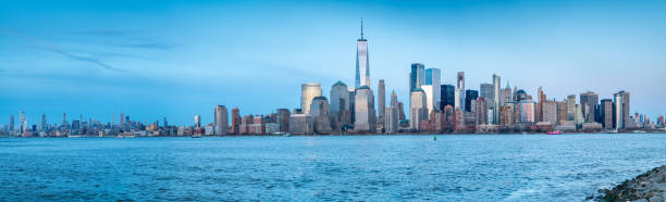 istock Panorama of Manhattan With Building Lights Coming On 1144250933