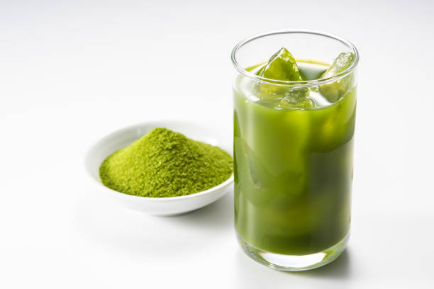 Pouring green juice into a glass