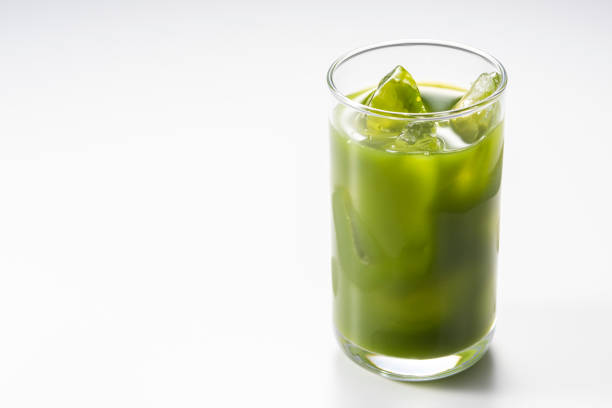 Pouring green juice into a glass