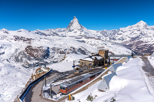 Matterhorn peak and Gornergrat railway station on top hill, Zermatt, Switzerland.
