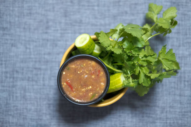 Spicy shrimp paste chilli sauce served with fresh cucumber and coriander, top view