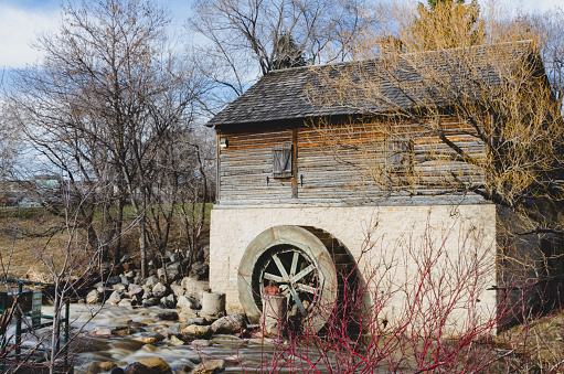 Sturgeon Creek water flowing past Cuthbert Grant's Mill in Springtime in Winipeg, Manitoba. Day.