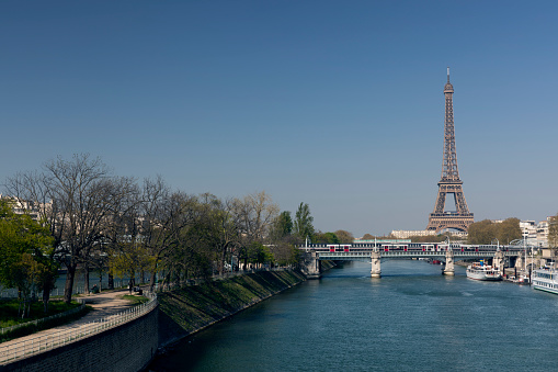 Paris, France - April 11, 2019: Afternoon view of the Seine River and Eiffel Tower from Pont de Grenelle.
