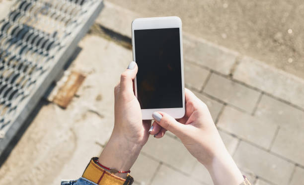 istock Female hands holding smartphone with blank screen 1144258109