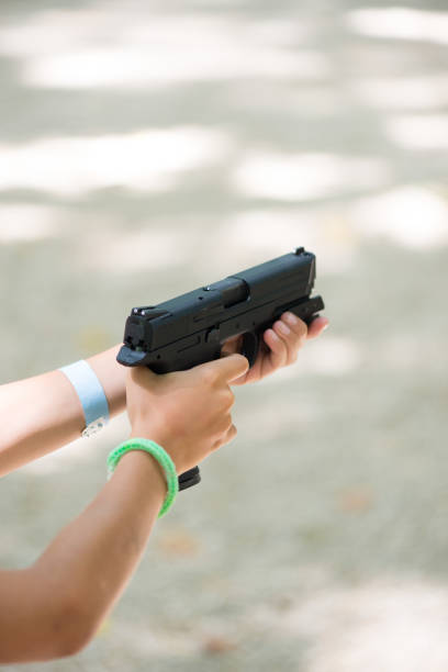 istock Little girl hands holding a target practice gun 1144258224