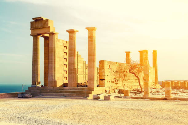 Ancient Greek acropolis. Front view of columns and walls. near the tree grows. Ancient Greek acropolis. Front view of the columns and walls. near the tree grows. acropole stock pictures, royalty-free photos & images