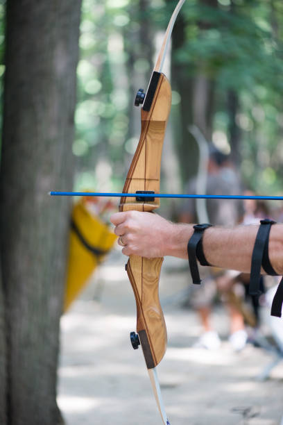 istock Man's hand aiming an arrow from big bow 1144259510