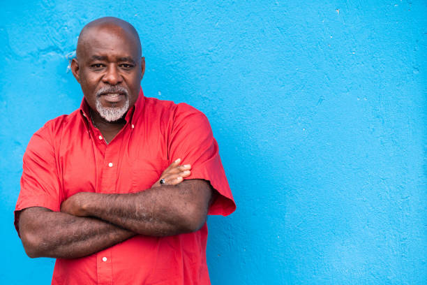istock Mature afro man portrait on blue background 1144260906