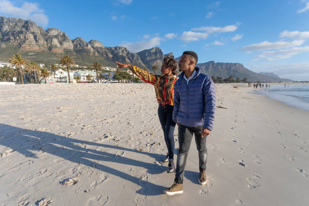 Happy African Couple Walking on the Beach at Camps Bay, Cape Town South Africa