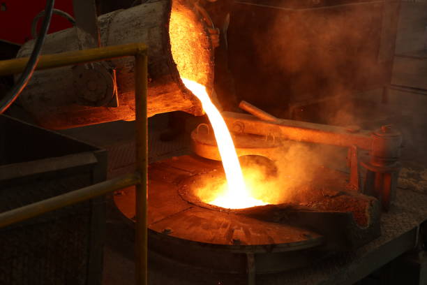 istock Molten iron pour from ladle into melting furnace 1144266252