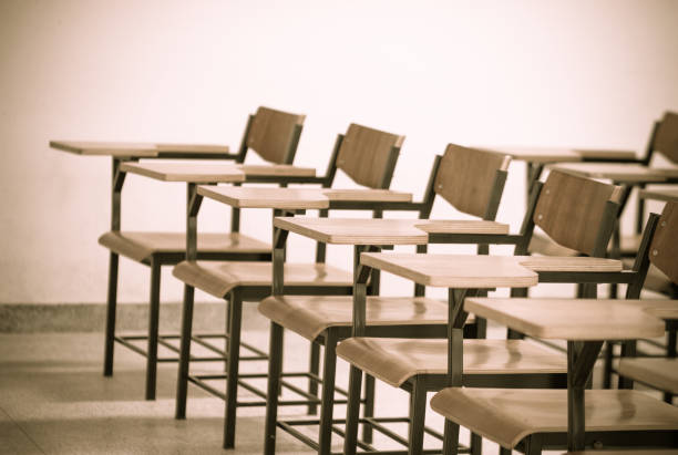 istock Chair in empty classroom, lecture armchairs in school 1144266369