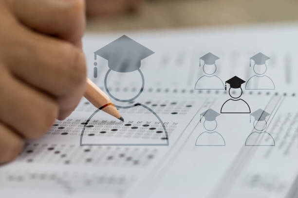 istock Education school test concept : Hands student holding pencil for testing exams writing answer sheet or exercise for taking fill in admission exam multiple carbon paper computer at university classroom 1144266532