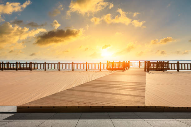 istock Lakeside wood floor platform and sky clouds at sunset 1144270242