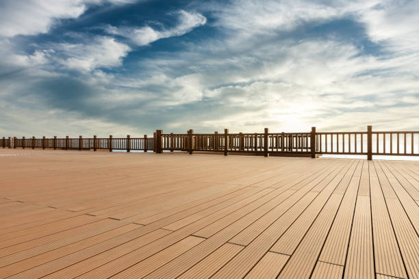 istock Lakeside wood floor platform and sky clouds at sunset 1144270304