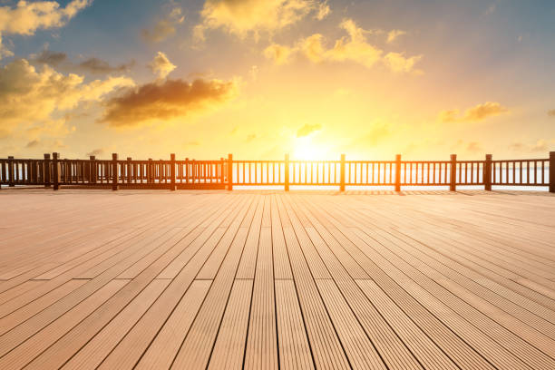 Photo of Lakeside wood floor platform and sky clouds at sunset