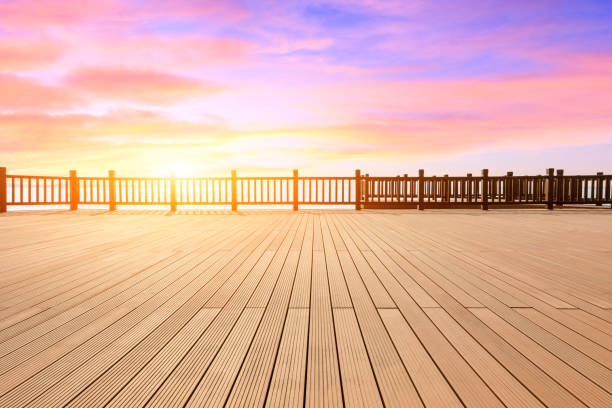 istock Lakeside wood floor platform and sky clouds at sunset 1144271608
