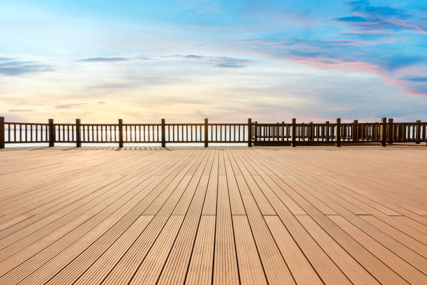 istock Lakeside wood floor platform and sky clouds at sunset 1144271660