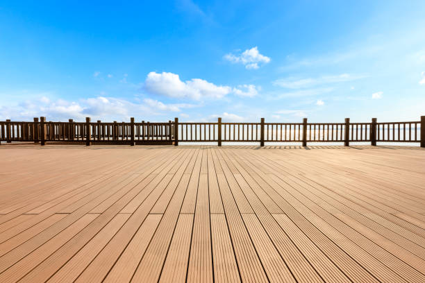 istock Lakeside wood floor platform and blue sky with white clouds 1144271732