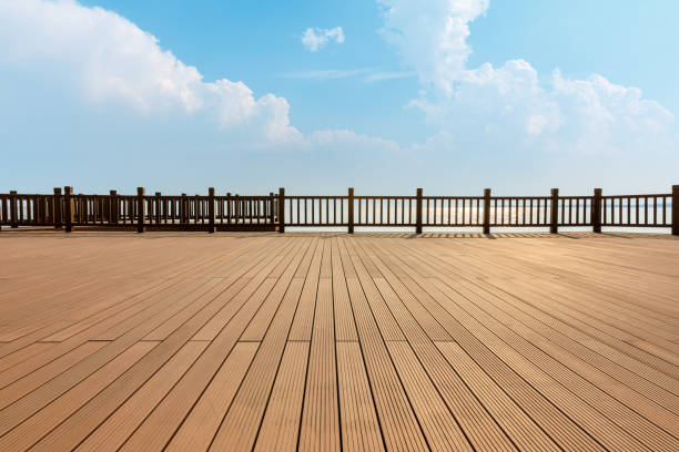 istock Lakeside wood floor platform and blue sky with white clouds 1144271762