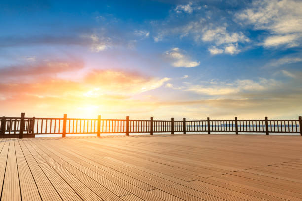 istock Lakeside wood floor platform and sky clouds at sunset 1144271808