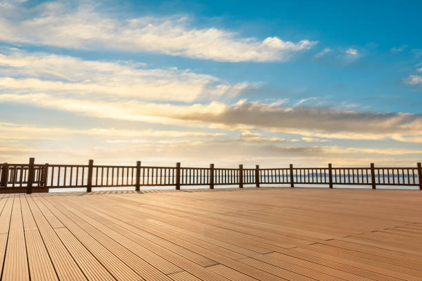 istock Lakeside wood floor platform and sky clouds 1144271860