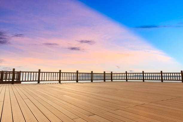 istock Lakeside wood floor platform and sky clouds at sunset 1144271902