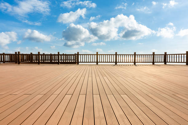 istock Lakeside wood floor platform and blue sky with white clouds 1144271956