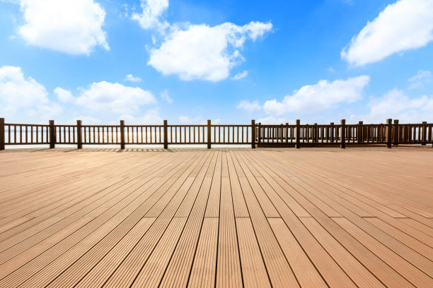 istock Lakeside wood floor platform and blue sky with white clouds 1144273397