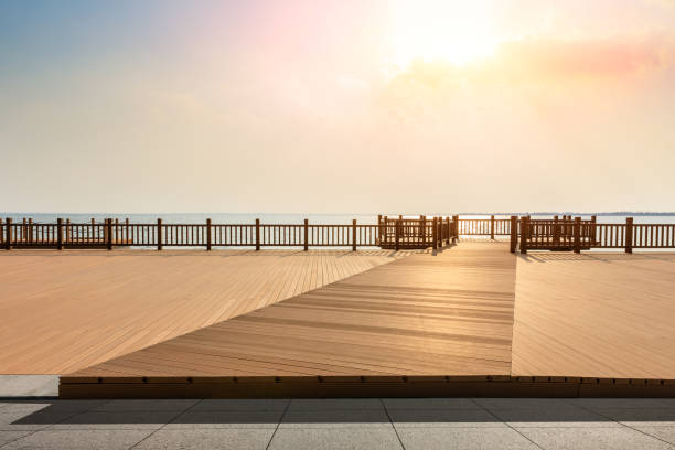 istock Lakeside wood floor platform and sky clouds at sunset 1144273486