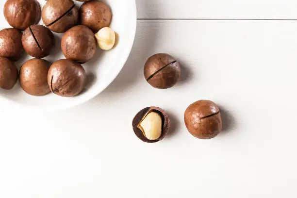 Top view macadamia nuts  on a wooden table