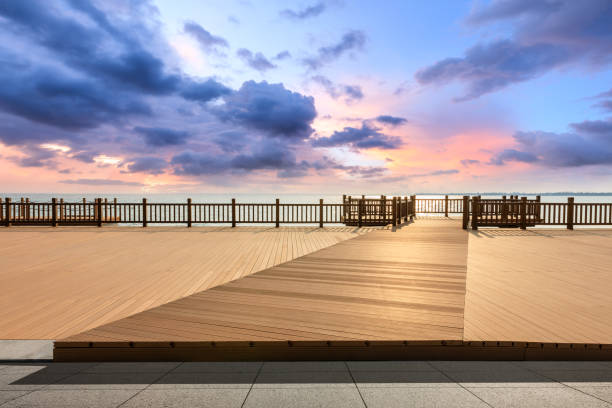 istock Lakeside wood floor platform and sky clouds at sunset 1144273539