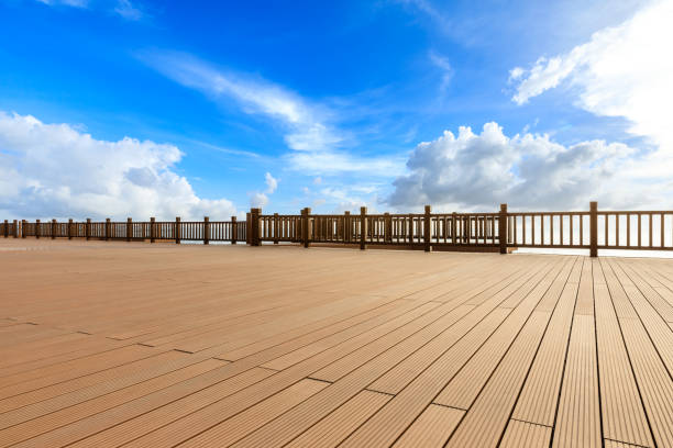 istock Lakeside wood floor platform and blue sky with white clouds 1144274640